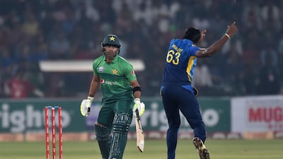 Sri Lanka's cricketer Nuwan Pradeep (R) successful appeal for leg before wicket (lbw) pas Pakistan's cricketer Kamran Akmal during the first Twenty20 International cricket match between Pakistan and Sri Lanka at the Gaddafi stadium in Lahore on October 5, 2019. Sri Lanka, boosted by a career-best half century from opener Danushka Gunathilaka, posted 165-5 against Pakistan in the first Twenty20 international in Lahore. / AFP / ARIF ALI
