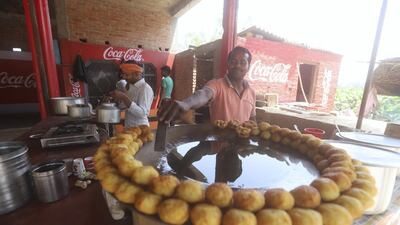 Amresh Kumar prepares snacks at roadside restaurant in Barabanki, Uttar Pradesh. Jitendra Prakash for The National