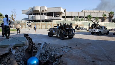 Rebel cars seen inside the main Moammar Gadhafi compound in Bab Al-Aziziya in Tripoli, LIbya, Tuesday, Aug. 23, 2011. Libyan rebels stormed Moammar Gadhafi's main military compound in Tripoli Tuesday after fierce fighting with forces loyal to his regime t???