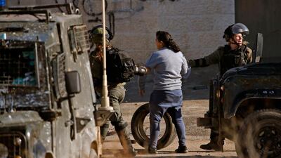 Israeli soldiers detain a Palestinian girl during clashes in Ramallah. AFP