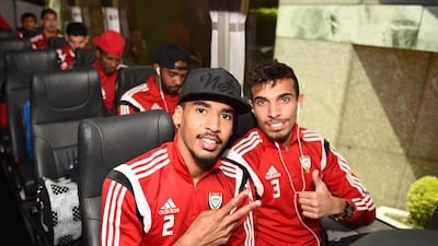Hassan Ibrahim, left, and Walid Abbas pose for a photo on the team bus.