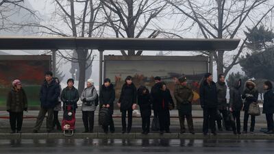 North Koreans wait for trolley bus at a bus stop in downtown Pyongyang, North Korea. AP Photo