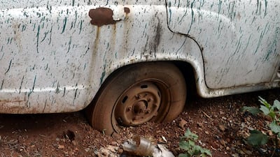 An unclaimed Ambassador car stands rusting on the parking lot of a local police station in Bangalore.