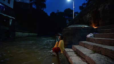 A Nepali Hindu devotee bathes in the holy Bagmati river during a partial lunar eclipse at the Pashupatinath temple area in Kathmandu. AFP / PRAKASH MATHEMA