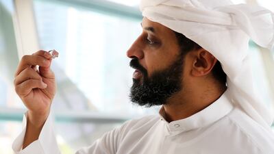 Ahmed Bin Sulayem, executive chairman and chief executive of DMCC, inspects the gemstone.