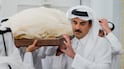 This handout photograph taken and released by Qatar's Amiri Diwan shows Qatar's Emir Sheikh Tamim bin Hamad Al Thani attending the funeral of his father, former leader Sheikh Hamad bin Khalifa Al Thani, at the Imam Mohammed ibn Abd Al Wahhab Mosque in Doha on July 12, 2026. Qatar's government on July 12 announced the death of Sheikh Hamad, who led the country from 1995 to 2013. He was 74, according to a government website. The former leader was seen as one of the key architects of modern Qatar and led the country during a period of rapid economic growth. He took power in June 1995, overthrowing his father in a bloodless coup while the latter was abroad. (Photo by Qatar Amiri Diwan / AFP) / RESTRICTED TO EDITORIAL USE - MANDATORY CREDIT "AFP PHOTO / QATAR'S AMIRI DIWAN" - HANDOUT - NO MARKETING NO ADVERTISING CAMPAIGNS - DISTRIBUTED AS A SERVICE TO CLIENTS