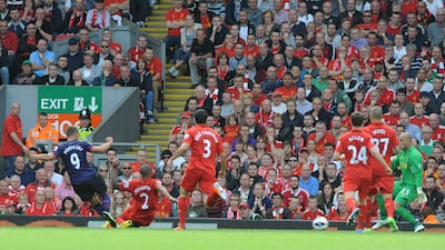 Arsenal's Lukas Podolski fires in the opening goal during the English Premier League at Anfield. Peter Powell/EPA