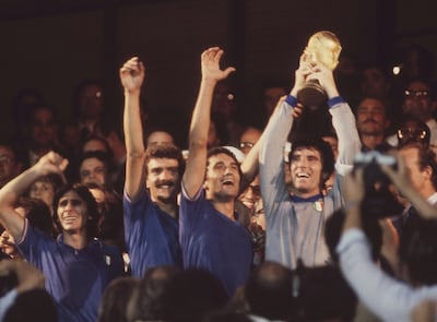 A photo from 1982 shows then-Italian captain and goalkeeper Dino Zoff, right, holding the World Cup trophy aloft, after the presentation ceremony, in Madrid. AP Photo