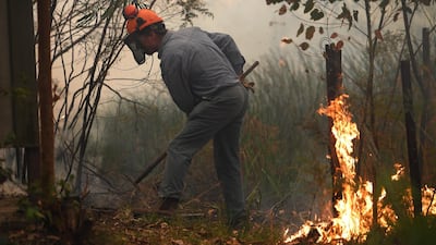 A resident works to protect his property in Kulnura as the a bushfire approaches Mangrove Mountain in the Austrlian state of New South Wales on December 6, 2019. EPA