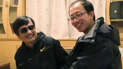 The blind Chinese activist Chen Guangcheng, left, meets with fellow activist Hu Jia at an undisclosed location recently. Chen escaped house arrest on April 22 and is believed to be at a secret location in Beijing.
