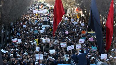 Iranian pro-government demonstrators march during the funeral of a young member of the Revolutionary Guard, Sajjad Shahsanai, in the city of Najafabad, west of Isfahan, on January 3, 2018. Morteza Salehi / Tasnim News / AFP