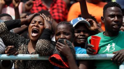 Mourners react emotionally as the coffin of former Zimbabwean President Robert Mugabe lies in state for public viewing at the Rufaro Stadium in Harare, Zimbabwe, The body is on view at the stadium for a second day. Mugabe died last week in Singapore at the age of 95. He led the southern African nation for 37 years before being forced to resign in late 2017. AP Photo