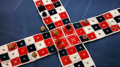 A Board Game Adventure at Louvre Abu Dhabi traces more than 5,000 years of board game history, including the evolution of Pachisi into Ludo. Victor Besa / The National