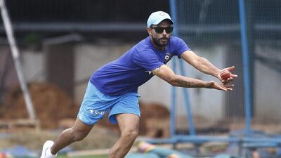 India cricketer Ravindra Jadeja stretches to catch the ball during a training camp at National Cricket Academy in Bangalore, India, Friday, July 1, 2016. Aijaz Rahi / AP Photo