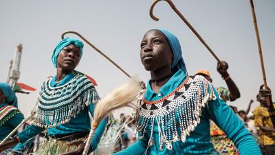 Members of traditional music and dance group perform before a rally for supporters of Sudan's ruling Transitional Military Council (TMC) in the village of Abraq. AFP