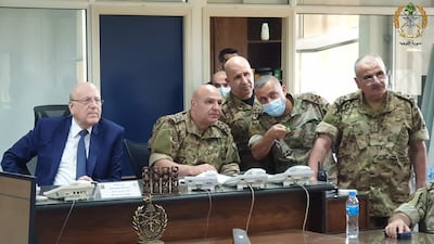 Lebanon's Prime Minister Najib Mikati, left, meeting Lebanese Armed Forces chief Joseph Aoun, centre, and military officials in Yarze, near Beirut. AFP