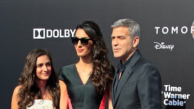 George and Amal Clooney, in a coral and black mini dress, at the premiere of Disney's 'Tomorrowland' in California on May 9, 2015. EPA