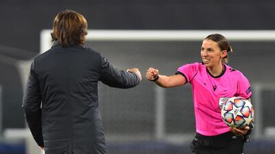 Stephanie Frappart, bumping fists with Juve manager Pirlo, became the first female to referee a men's Champions League match. Reuters