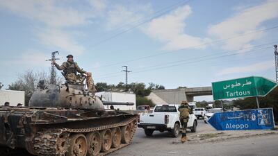 Syrian security forces on the outskirts of Latakia in the eastern coastal region during clashes with Al Assad loyalists early last month. AP