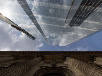A historical building alongside a modern skyscraper in the City of London. Bloomberg