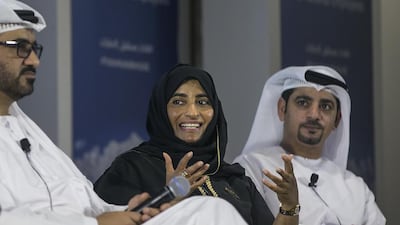 Ameena Al Marzooqi, a guest service agent at Etihad, flanked by Ali Al Shamsi, vice president Emiratisation strategy, left, and Faisal Al Mulla, senior manager, graduate engineering programme. Mona Al Marzooqi / The National