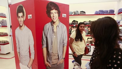 Fans check out the merchandise in the 1D World pop-up shop in The Dubai Mall. Sarah Dea / The National