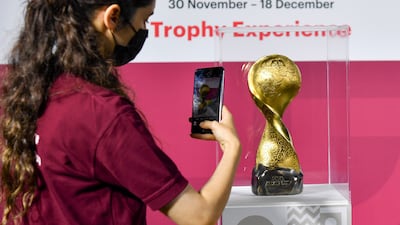 A woman takes a picture of the Fifa Arab Cup trophy displayed at Katara Cultural Village in Doha, Qatar, 25 November 2021. All photos: EPA