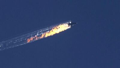 A still image from video footage shown by the HaberTurk TV Channel shows a burning trail as a Russian plane comes down near the Turkish-Syrian border (EPA/HABERTURK TV CHANNEL)