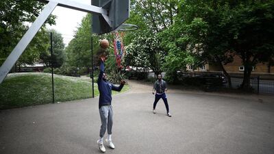 Basketball player Taiwo Badmus and Baba Bob-Soile play in a park in Elephant and Castle, London. Reuters