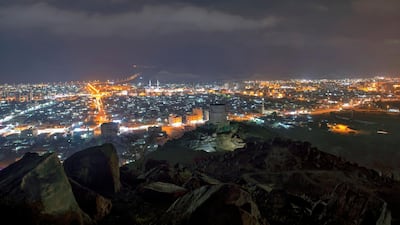 Khor Fakkan town at night with a historic fort pictured in the foreground. Courtesy: Sharjah Government / Wam