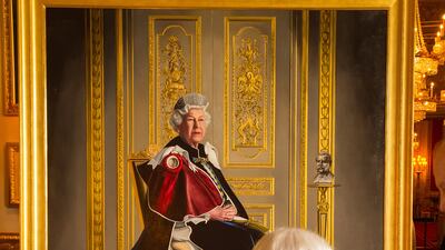 Queen Elizabeth views a portrait of her by British artist Henry Ward that marked six decades of patronage to the British Red Cross. Getty