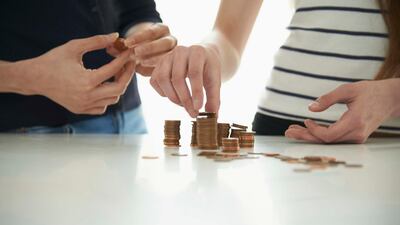 Teenagers look to their parents to set the right example when it comes to managing finances. Getty Images
