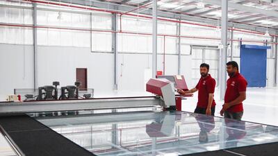 Workers manufacture glass products in Streit Group’s new APG facility. Sarah Dea / The National