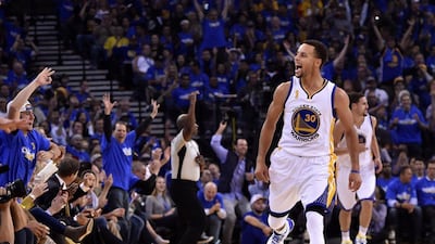 Golden State Warriors guard Stephen Curry reacts after sinking a three point shot during the NBA season opening game against the New Orleans Pelicans on Tuesday. John G Mabanglo / EPA / October 27, 2015