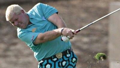 John Daly hits his approach shot to the 13th green.