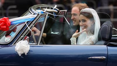 Prince William, Duke of Cambridge, and Kate, Duchess of Cambridge, drive from Buckingham Palace to Clarence House in a vintage Aston Martin after their wedding reception in 2011.