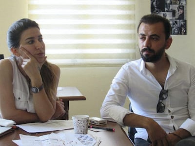 Suna Ertas (L) and Emin Coban prepare to head to a polling station. Photo by Mat Nashed