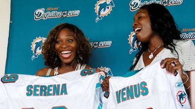 Serena, left, and Venus Williams with their Miami Dolphins jerseys after it was announced the tennis stars had become minority owners of the NFL team in 2009. AP