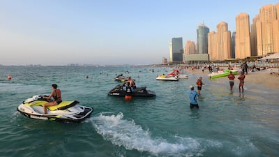 People relax on the beach, with temperatures on the coast expected to reach 35°C on Tuesday. Getty