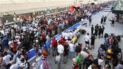 Fans fill the pit lane as ticket holders get their first chance to see the track yesterday.