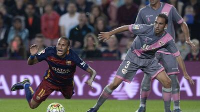 Neymar of Barcelona is fouled in the box and awarded a penalty on Saturday night during his team’s La Liga contest against Rayo Vallecano. Josep Lago / AFP