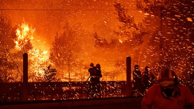 Firefighters try to tackle a wildfire to the north of Greek capital Athens in 2021. Getty Images