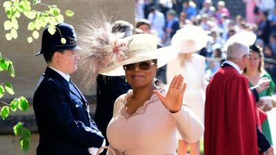 Oprah Winfrey waves as she arrives at St George's Chapel at Windsor Castle the wedding ceremony of Prince Harry and Meghan Markle at St. George's Chapel in Windsor Castle in Windsor. Ian West / AP Photo