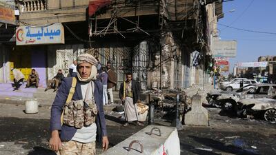 Armed Yemenis stand guard at a street leading to the residence of Yemen’s ex-president Ali Abdullah Saleh a day after Houthi militants killed him, in Sana’a, Yemen. Yahya Arhab / EPA
