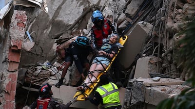 A major earthquake has struck Venezuela. Rescue workers carry a person on a stretcher out of a collapsed building in Caracas. AFP
