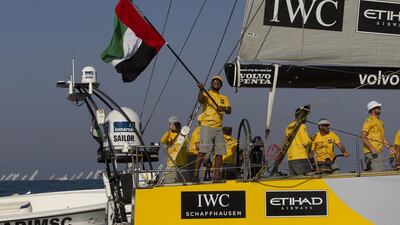 Adil Khalid waves the UAE flag as Azzam sails into port on Saturday in Abu Dhabi at the end of Leg 2 of the Volvo Ocean Race. Ian Roman / Abu Dhabi Ocean Racing