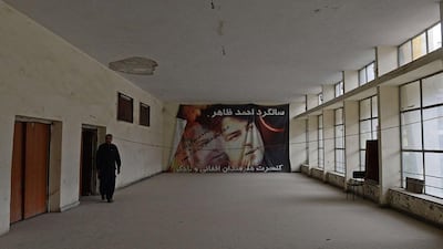 Qaisullah Aryobwal, son of Mohammad Karim Aryobwal who is the owner of the abandoned Aryob Cinema, walks in the hallway of his father's cinema.