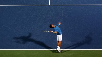 Serbian Novak Djokovic serves the ball to Spanish Tommy Robredo during their ATP tennis match on the first round of the Dubai Duty Free Tennis Championships on February 22, 2016. / AFP / KARIM SAHIB