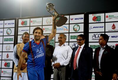 Afghanistan captain Asghar Stanikzai collects the trophy after beating Bangladesh in their T20 series in India. AP
