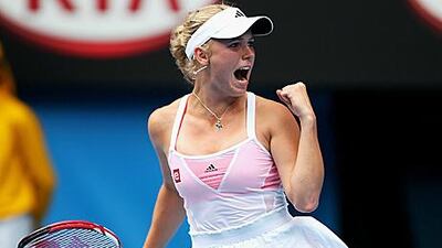 Caroline Wozniacki clenches her fist after battling back to beat Fracesca Schiavone.